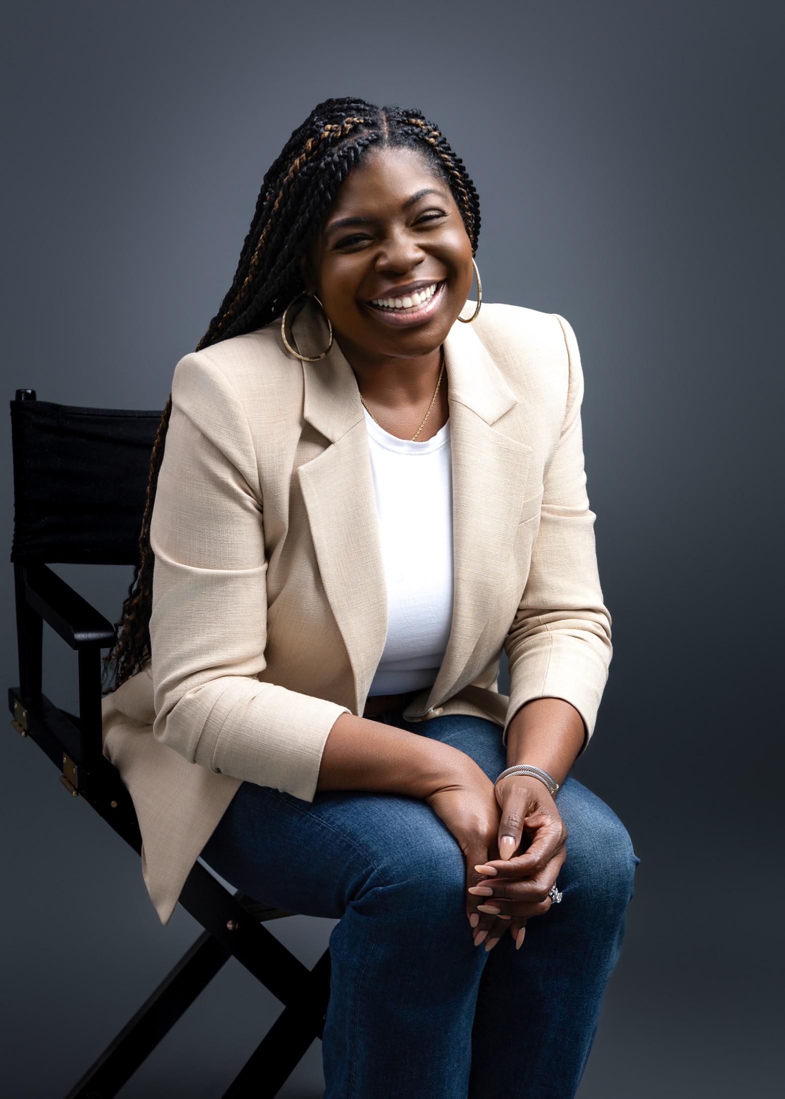 Summer C. Martin laughing while seated in a studio